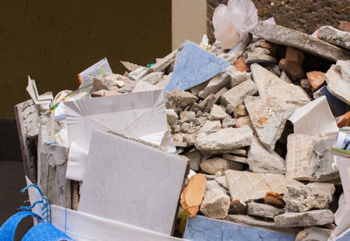 pile of crumbled concrete, drywall, and debris